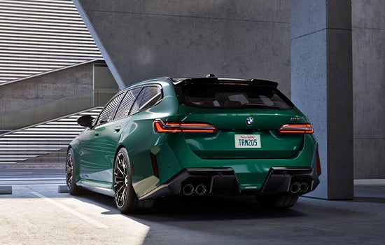 Green BMW M5 Touring parked in garage. | BMW of Grand Blanc in Grand Blanc MI
