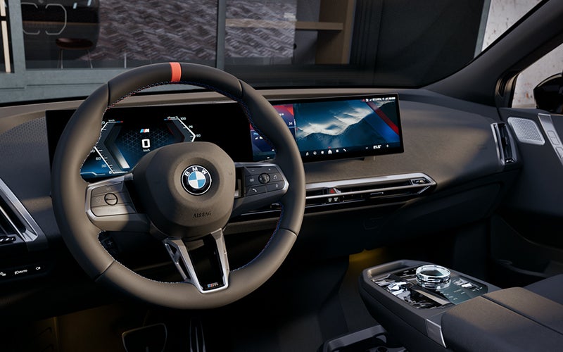 Interior steering wheel and dashboard of the BMW iX M70. | BMW of Grand Blanc in Grand Blanc MI
