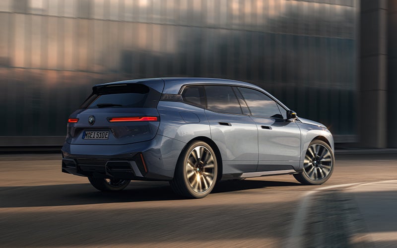 The BMW iX driving with the front wheel turned. | BMW of Grand Blanc in Grand Blanc MI