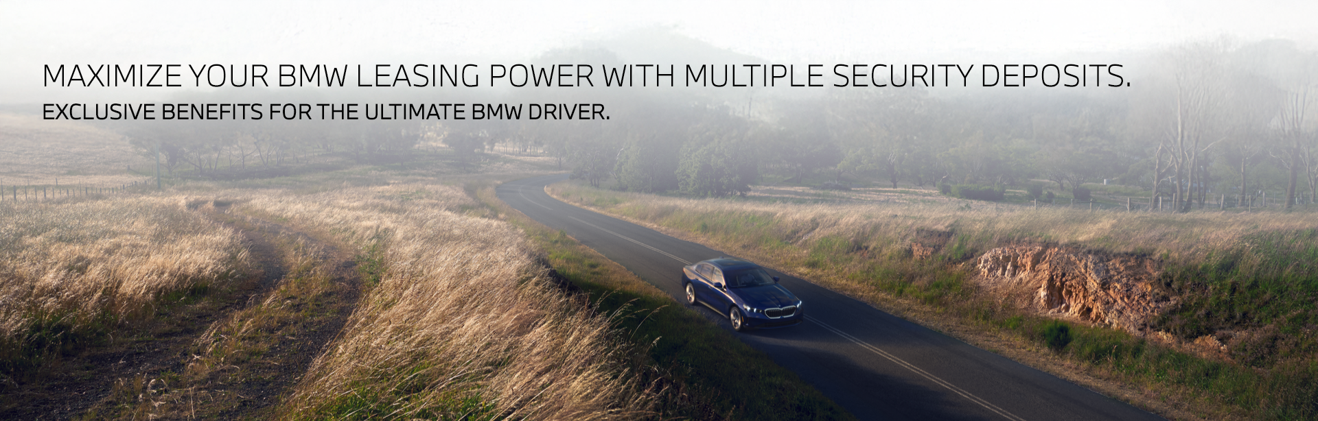 BMW driving through country road.