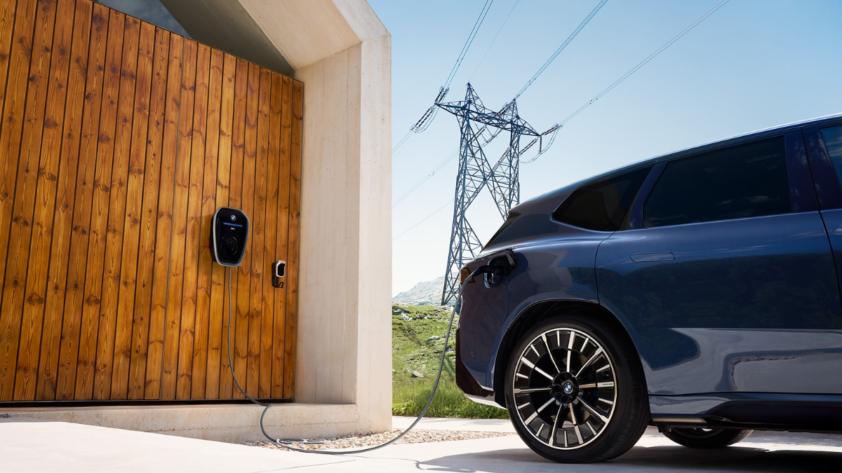 2027 BMW iX3 connected to an electric vehicle charger