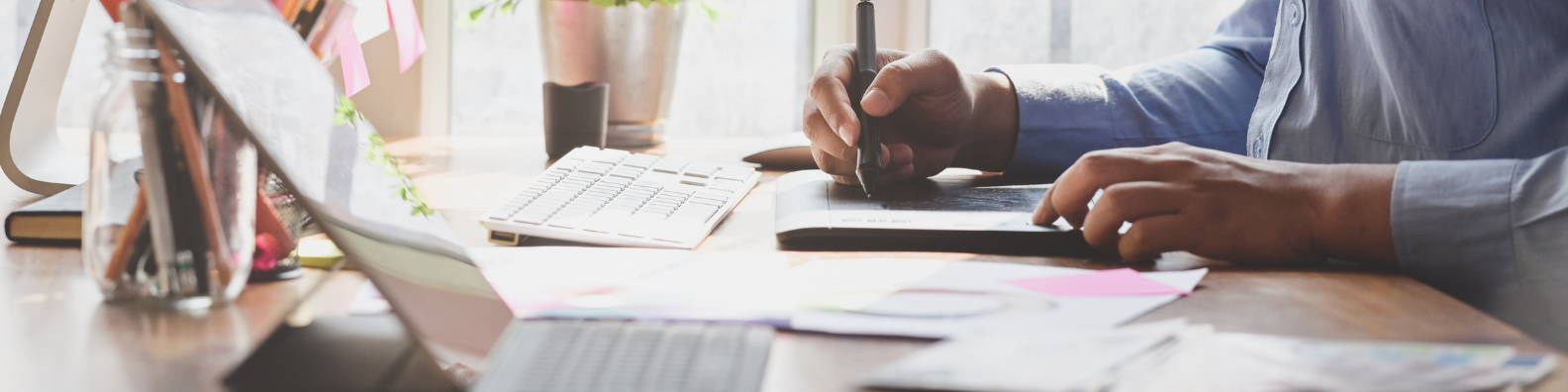 a desk with papers all around and a man